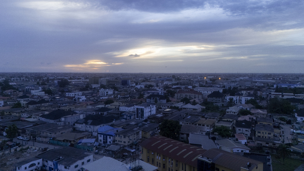Aerial view of Allen Avenue and the surrounding urban landscape with dense rooftops under a cloudy sunset sky in Ikeja Lagos Nigeria. Aerial view of Allen Avenue and the surrounding urban landscape with dense rooftops under a cloudy sunset sky in Ikeja Lagos Nigeria.