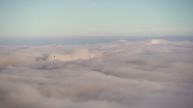 View of wind turbines above clouds in Balkan Mountains Bulgaria.