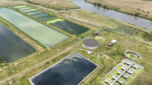 Aerial view of a water treatment plant with rectangular settling ponds and circular tanks near the Vaal River in Villiers Free State South Africa. Aerial view of a water treatment plant with rectangular settling ponds and circular tanks near the Vaal River in Villiers Free State South Africa.