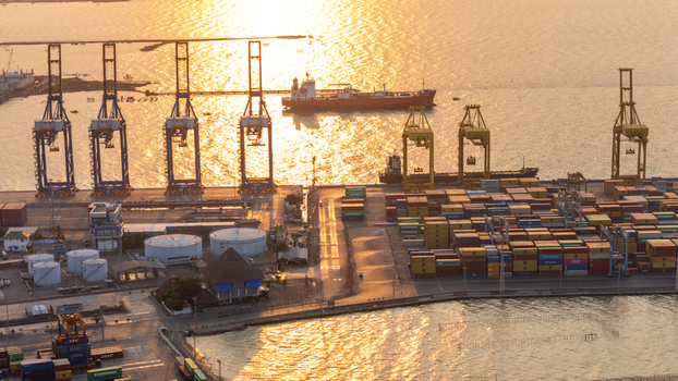 Semarang Indonesia 27 September 2026 Aerial view of the port with colorful shipping containers industrial cranes and cargo ships docked along the waterfront at sunset. Semarang Indonesia 27 September 2026 Aerial view of the port with colorful shipping containers industrial cranes and cargo ships docked along the waterfront at sunset.