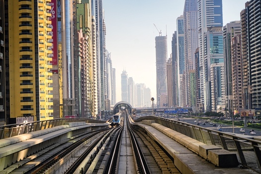 Dubai Dubai United Arab Emirates 21 April 2023 View of the Dubai Metro tracks leading through the modern skyscrapers and urban skyline of Dubai United Arab Emirates. Dubai Dubai United Arab Emirates 21 April 2023 View of the Dubai Metro tracks leading through the modern skyscrapers and urban skyline of Dubai United Arab Emirates.