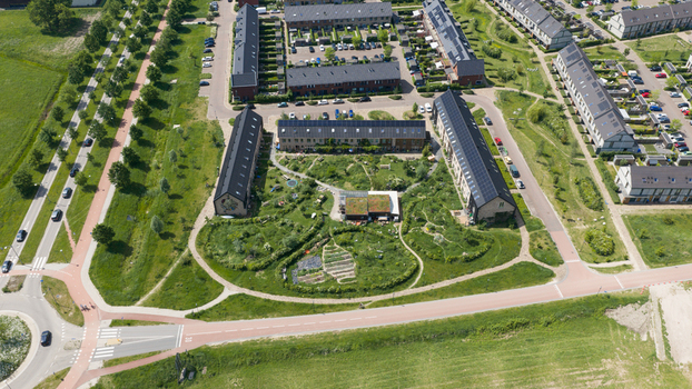 Aerial view of Ecodorp Zuiderveld featuring solar panels on rooftops and lush communal gardens in Nijmegen Gelderland Netherlands. Aerial view of Ecodorp Zuiderveld featuring solar panels on rooftops and lush communal gardens in Nijmegen Gelderland Netherlands.