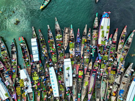 Rangamati Hill District Chittagong Division Bangladesh 18 May 2024 Aerial view of Kaptai Lake filled with wooden boats carrying produce and people navigating the busy waterway.
