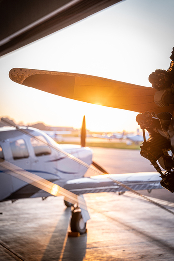 View of a Boeing Stearman biplane propeller and engine inside a hangar during golden hour at Langenhagen Niedersachsen Germany. View of a Boeing Stearman biplane propeller and engine inside a hangar during golden hour at Langenhagen Niedersachsen Germany.