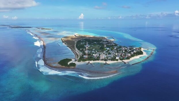 Aerial view of Thulusdhoo island with turquoise lagoons Maldives. Aerial view of Thulusdhoo island with turquoise lagoons Maldives.
