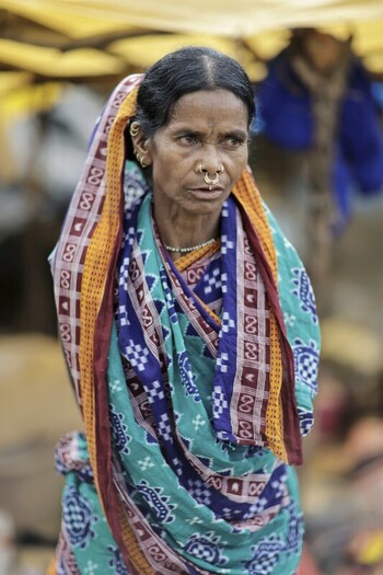 Odisha India 26 March 2026 View of a woman with a weathered face draped in a vibrant saree with intricate patterns and bold colors standing against a blurred background. Odisha India 26 March 2026 View of a woman with a weathered face draped in a vibrant saree with intricate patterns and bold colors standing against a blurred background.