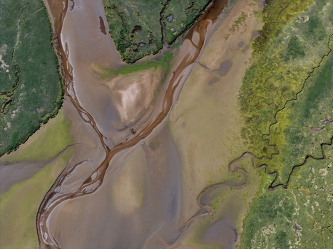 Aerial view of Findhorn Bay with meandering water channels sandy banks and green marshland Findhorn Scotland United Kingdom. Aerial view of Findhorn Bay with meandering water channels sandy banks and green marshland Findhorn Scotland United Kingdom.