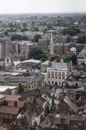 Aerial view of the Mansion House surrounded by historic red brick rooftops and narrow streets in York England United Kingdom.