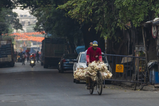 Kolkata India 06 December 2024 View of a cyclist laden with goods navigating the bustling streets near Howrah Bridge amidst a vibrant mix of vehicles and pedestrian activity. Kolkata India 06 December 2024 View of a cyclist laden with goods navigating the bustling streets near Howrah Bridge amidst a vibrant mix of vehicles and pedestrian activity.