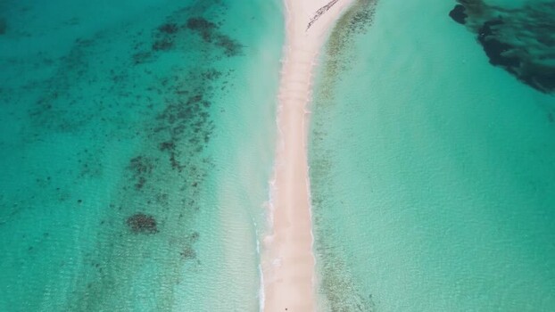 Aerial view of Los Roques sandbar in turquoise water Venezuela.