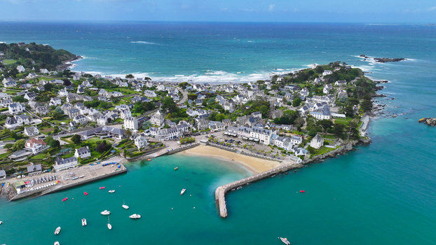 Aerial view of the Locquirec peninsula with its white houses sandy beach and stone pier overlooking the turquoise sea Locquirec Brittany France. Aerial view of the Locquirec peninsula with its white houses sandy beach and stone pier overlooking the turquoise sea Locquirec Brittany France.