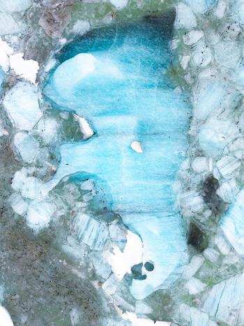 Aerial view of the glacial lagoon s teal waters amidst jagged ice floes creating a stark contrast of colors and textures &Ouml;r&aelig;fi Iceland.