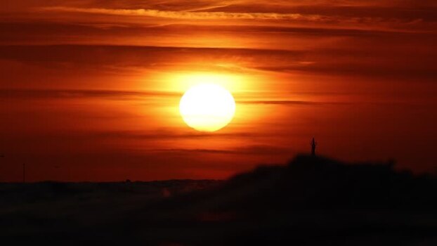 View of a fiery sunset over distant structures France. View of a fiery sunset over distant structures France.