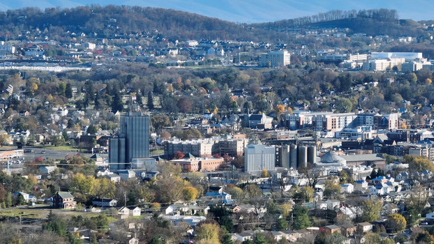 Aerial view of the cityscape of Harrisonburg featuring industrial grain silos residential neighborhoods and autumn foliage Harrisonburg Virginia United States.