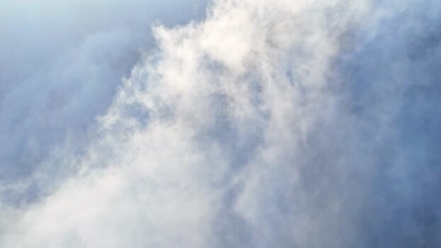 Aerial view of thick white clouds and misty atmosphere Austria.