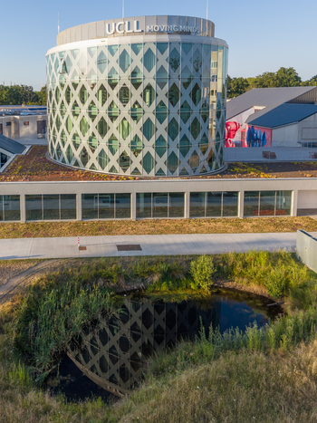Diepenbeek Belgium 01 July 2026 Aerial view of the UCLL Campus Diepenbeek featuring its modern circular glass building with a diamond patterned facade pond and green landscape. Diepenbeek Belgium 01 July 2026 Aerial view of the UCLL Campus Diepenbeek featuring its modern circular glass building with a diamond patterned facade pond and green landscape.