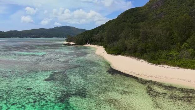 Aerial view of the white sandy beach and turquoise waters Seychelles.