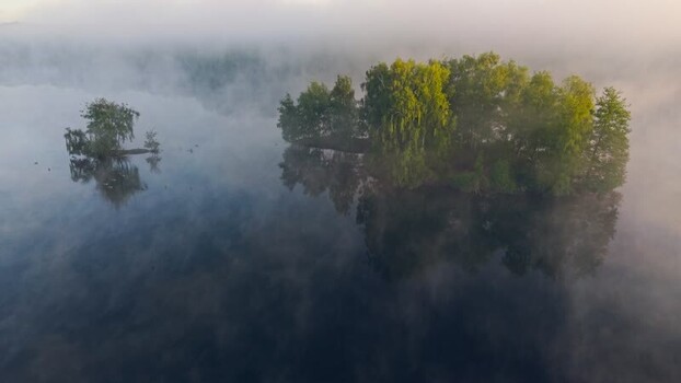 Aerial view of Venekotensee lake with misty islands Germany.