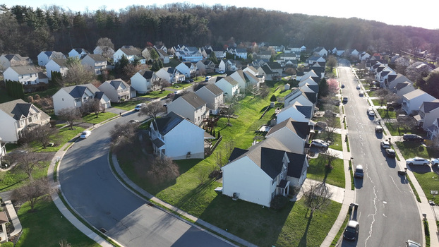 Aerial view of the residential neighborhood of Hempfield in spring featuring suburban houses with green lawns winding streets and trees in Rohrerstown Pennsylvania United States.