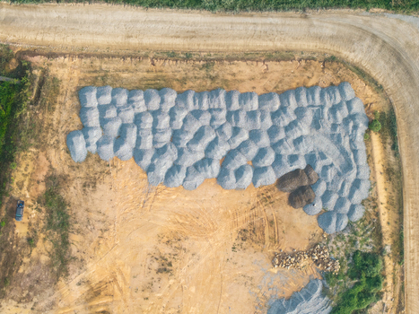 Aerial view of construction area with large piles of gravel and sand on a cleared dirt site in Bukit Tambun Penang Malaysia. Aerial view of construction area with large piles of gravel and sand on a cleared dirt site in Bukit Tambun Penang Malaysia.