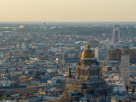 Aerial view of the Palais de Justice with its golden dome overlooking the urban skyline of Brussels at sunset with the Atomium visible in the distance in Brussels Brussels Belgium. Aerial view of the Palais de Justice with its golden dome overlooking the urban skyline of Brussels at sunset with the Atomium visible in the distance in Brussels Brussels Belgium.