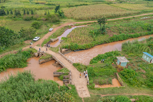Aerial view of a small bridge crossing a muddy river in the rural landscape of Butaleja Eastern Region Uganda. Aerial view of a small bridge crossing a muddy river in the rural landscape of Butaleja Eastern Region Uganda.