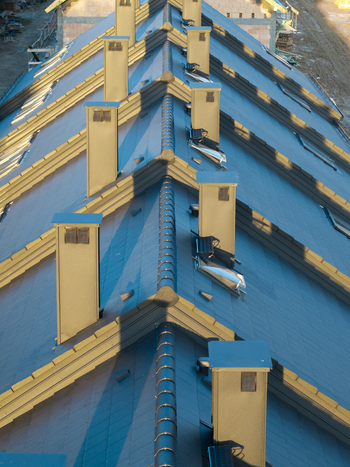Aerial view of row houses under construction with dark tiled roofs and chimneys in Wieliczka Lesser Poland Voivode Poland.