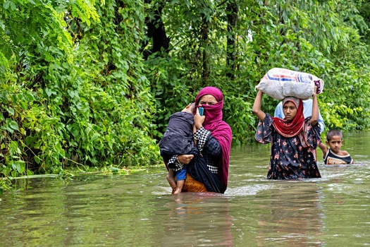 Banshkhali Upazila Chittagong Division Bangladesh 10 July 2026 View of women and children wading through deep floodwaters in a rural area. Banshkhali Upazila Chittagong Division Bangladesh 10 July 2026 View of women and children wading through deep floodwaters in a rural area.