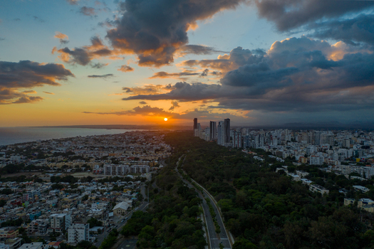 Aerial view of Mirador Sur park with lush greenery and the modern skyline of Santo Domingo at sunset Santo Domingo Distrito Nacional Dominican Republic. Aerial view of Mirador Sur park with lush greenery and the modern skyline of Santo Domingo at sunset Santo Domingo Distrito Nacional Dominican Republic.