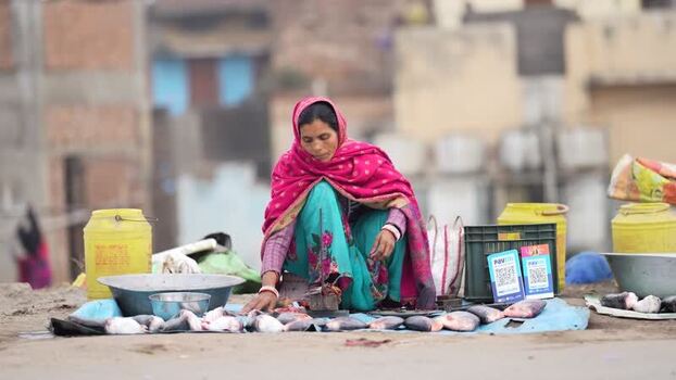 View of a woman selling fish in a local market in Patna India.