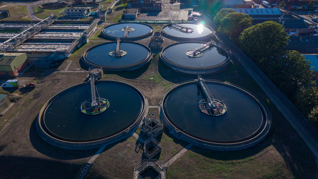 Aerial view of the Water Treatment Centre Camberley featuring large circular settling tanks and industrial infrastructure in Camberley England United Kingdom. Aerial view of the Water Treatment Centre Camberley featuring large circular settling tanks and industrial infrastructure in Camberley England United Kingdom.