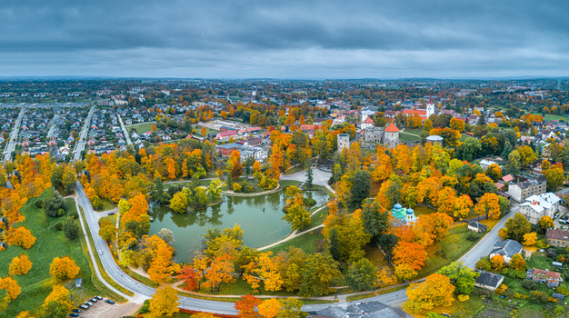 Aerial view of Cesis Castle ruins surrounded by vibrant autumn foliage a serene pond and the historic townscape of Cesis Cesis Municipality Latvia. Aerial view of Cesis Castle ruins surrounded by vibrant autumn foliage a serene pond and the historic townscape of Cesis Cesis Municipality Latvia.