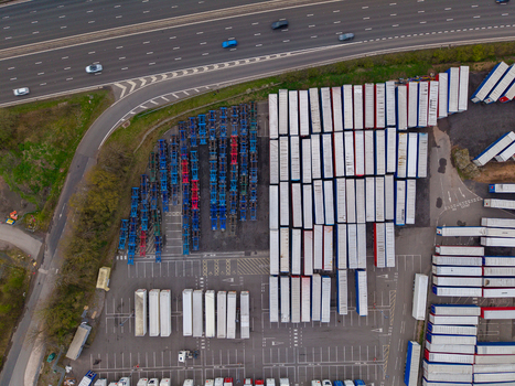 Aerial view of the logistics yard at Doxey Marshes with rows of shipping containers and trailers parked near the highway in Stafford England United Kingdom. Aerial view of the logistics yard at Doxey Marshes with rows of shipping containers and trailers parked near the highway in Stafford England United Kingdom.