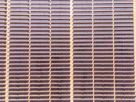 Aerial view of rows of solar panels in a large photovoltaic power station in the desert Lucerne Valley California United States. Aerial view of rows of solar panels in a large photovoltaic power station in the desert Lucerne Valley California United States.