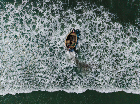Cox s Bazar Bangladesh 10 March 2026 Aerial view of a traditional wooden fishing boat navigating through white foamy waves in the turquoise sea. Cox s Bazar Bangladesh 10 March 2026 Aerial view of a traditional wooden fishing boat navigating through white foamy waves in the turquoise sea.