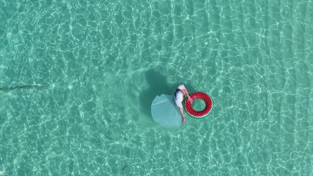 Aerial view of a person with a watermelon ring in water Maldives.