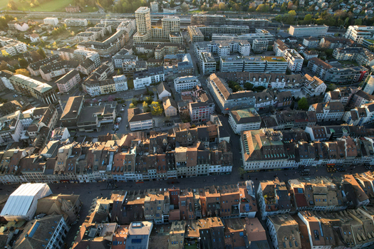 Aerial view of the historic rooftops and modern architecture of the city center during golden hour in Morges Vaud Switzerland. Aerial view of the historic rooftops and modern architecture of the city center during golden hour in Morges Vaud Switzerland.