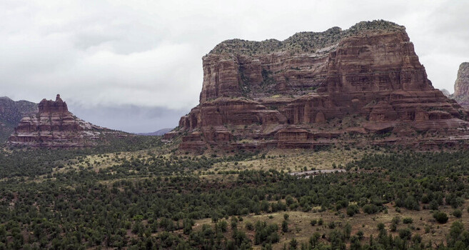 Aerial view of Courthouse Butte and Bell Rock red rock formations rising above the desert landscape in Sedona AZ United States. Aerial view of Courthouse Butte and Bell Rock red rock formations rising above the desert landscape in Sedona AZ United States.
