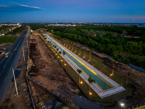 Aerial view of the Casa Arquidiocesana Maria de La Altagracia with a long reflecting pool and palm trees at dusk in Santo Domingo Este Santo Domingo Province Dominican Republic. Aerial view of the Casa Arquidiocesana Maria de La Altagracia with a long reflecting pool and palm trees at dusk in Santo Domingo Este Santo Domingo Province Dominican Republic.