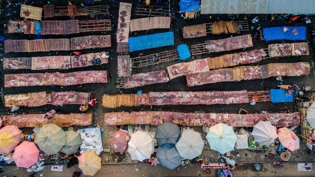 Aerial view of Panteka Market with colorful umbrellas people and goods displayed on wooden stalls and mats in Kaduna Kaduna Nigeria. Aerial view of Panteka Market with colorful umbrellas people and goods displayed on wooden stalls and mats in Kaduna Kaduna Nigeria.
