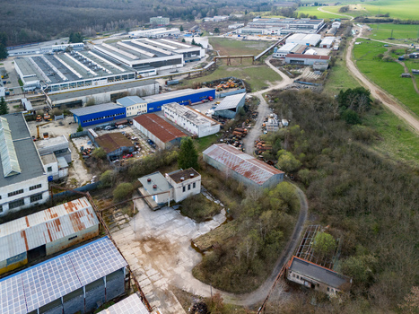 Aerial view of industrial buildings juxtapose with nature s embrace showcasing a blend of manufacturing and greenery Detva Banskobystricky kraj Slovakia. Aerial view of industrial buildings juxtapose with nature s embrace showcasing a blend of manufacturing and greenery Detva Banskobystricky kraj Slovakia.