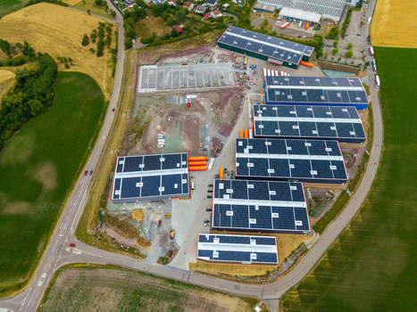 Aerial view of Serways Raststatte Hohenlohe Sud featuring industrial buildings with solar panels surrounded by fields and a highway in Neuenstein Baden Wurttemberg Germany. Aerial view of Serways Raststatte Hohenlohe Sud featuring industrial buildings with solar panels surrounded by fields and a highway in Neuenstein Baden Wurttemberg Germany.