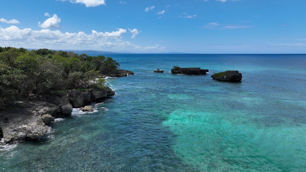 Aerial view of the rocky coastline and turquoise waters of the Caribbean Sea near Rio San Juan Maria Trinidad Sanchez Dominican Republic. Aerial view of the rocky coastline and turquoise waters of the Caribbean Sea near Rio San Juan Maria Trinidad Sanchez Dominican Republic.