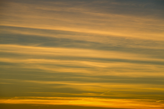 View of golden and blue hues paint the sky with streaks of clouds during sunset creating a mesmerizing atmospheric spectacle Sommeralm Steiermark Austria. View of golden and blue hues paint the sky with streaks of clouds during sunset creating a mesmerizing atmospheric spectacle Sommeralm Steiermark Austria.