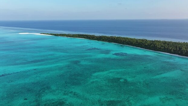 Aerial view of the lush tropical island of Fulhadhoo Maldives. Aerial view of the lush tropical island of Fulhadhoo Maldives.