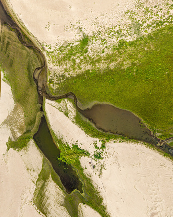 Aerial view of the Vistula river showing winding water channels sandy banks and lush green vegetation in Warsaw Masovian Voivodeship Poland. Aerial view of the Vistula river showing winding water channels sandy banks and lush green vegetation in Warsaw Masovian Voivodeship Poland.