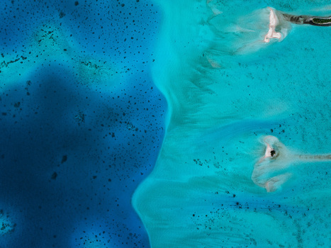 Aerial view of vibrant turquoise lagoon waters with coral reefs and white sandbars in Moorea Maiao Windward Islands French Polynesia. Aerial view of vibrant turquoise lagoon waters with coral reefs and white sandbars in Moorea Maiao Windward Islands French Polynesia.