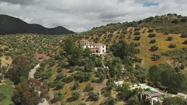 Aerial view of a white villa on a hillside in Andalucia Spain.