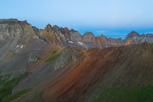 Aerial view of Mount Sneffels in the San Juan Mountains with rugged rocky peaks and alpine slopes in Ouray County Colorado United States. Aerial view of Mount Sneffels in the San Juan Mountains with rugged rocky peaks and alpine slopes in Ouray County Colorado United States.