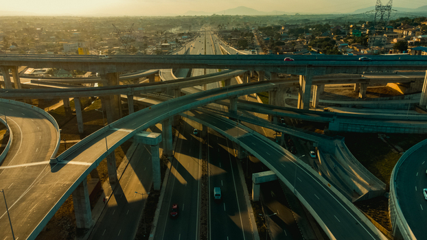 Aerial view of Pokuase Interchange with multi level highway ramps concrete pillars and vehicles in urban landscape during golden hour in Ga North Municipal Greater Accra Region Ghana. Aerial view of Pokuase Interchange with multi level highway ramps concrete pillars and vehicles in urban landscape during golden hour in Ga North Municipal Greater Accra Region Ghana.